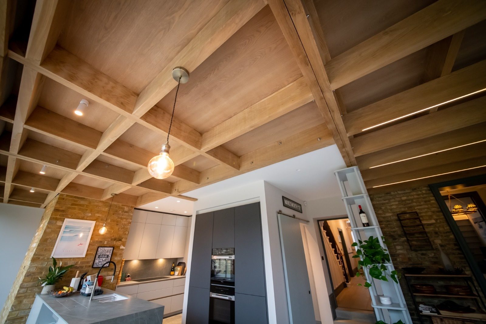 Rewired open-plan kitchen and living space with pendant lighting, downlights and LED strip circuits