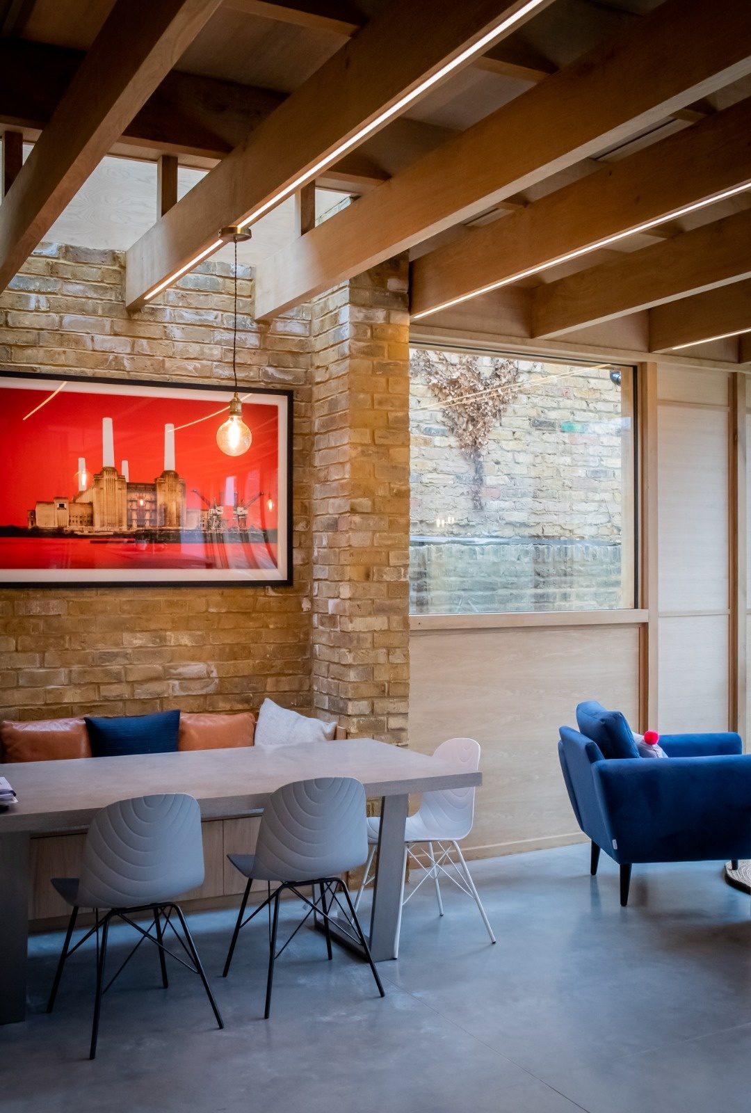 Part rewire in an Essex home with recessed linear LED lighting set into oak ceiling beams above a dining area