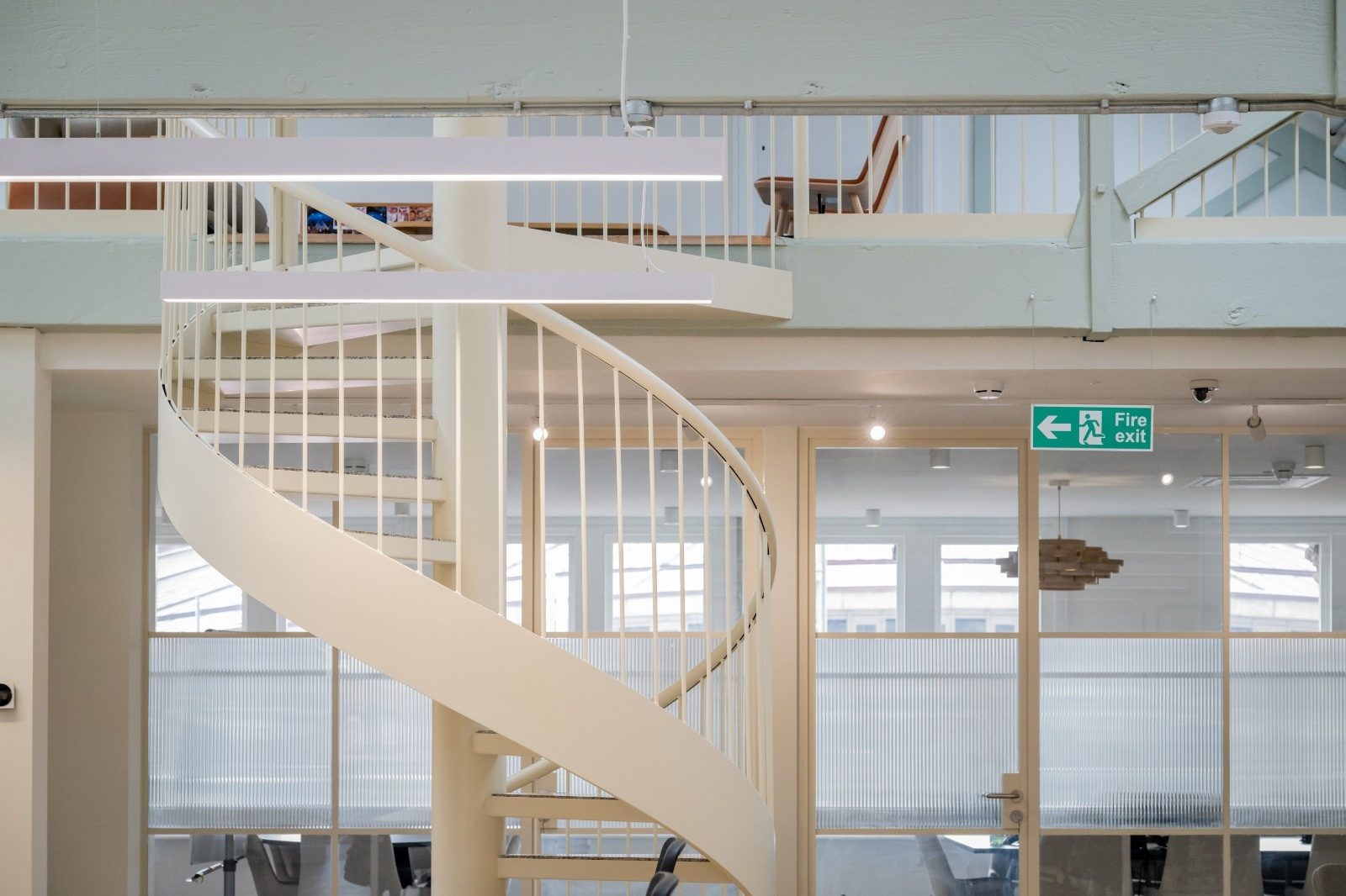Suspended linear light fittings and emergency lighting installed during a commercial office fit-out