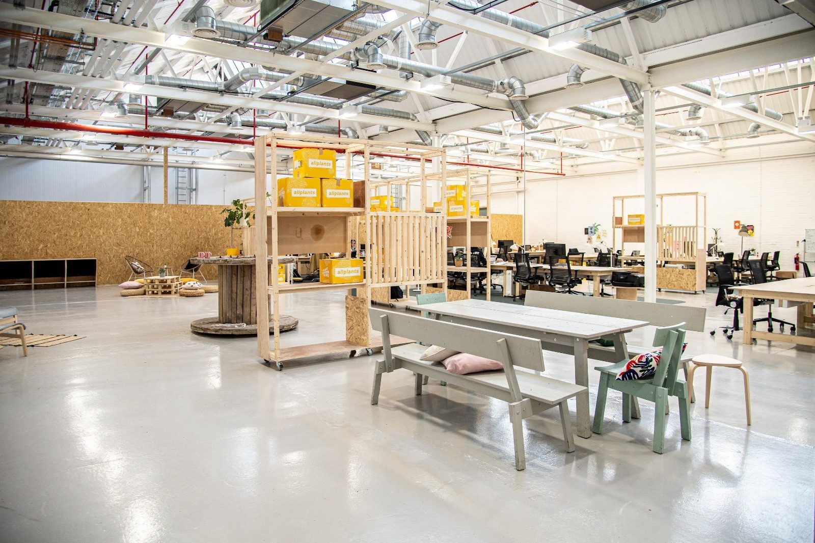 Warehouse office fit-out with surface-mounted lighting and power installed to timber workspaces
